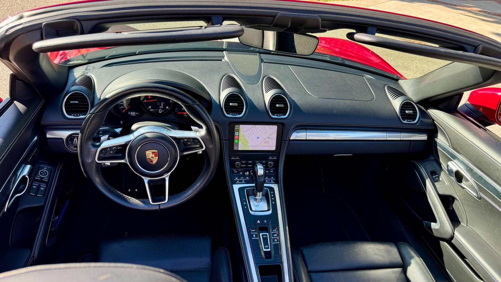 Cockpit of the Porsche 718 Boxster with the roof down