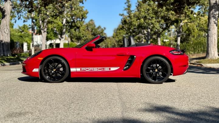 Red Porsche 718 Boxster convertible available to rent in Los Angeles, front three-quarter view