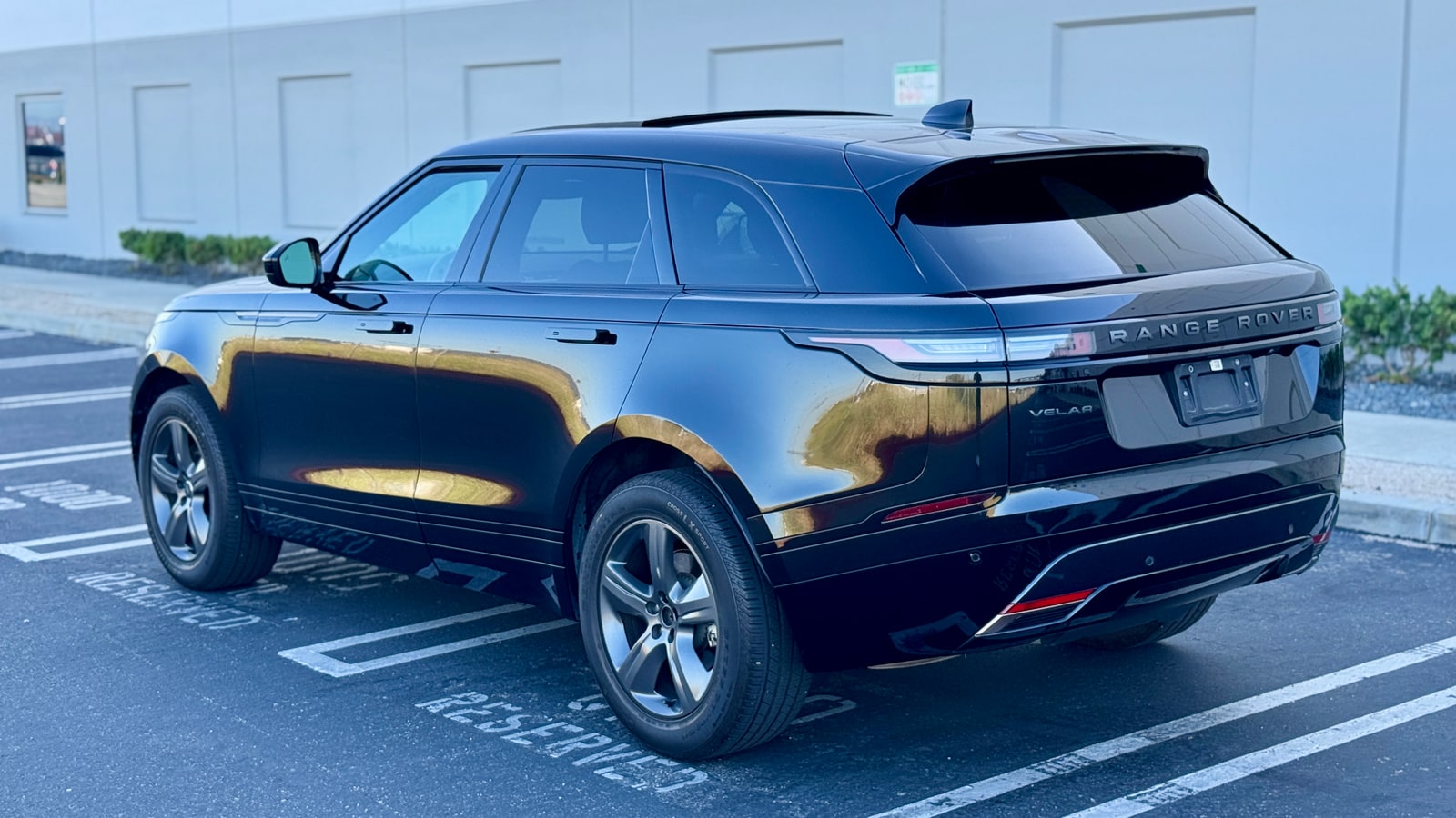 Black Range Rover Velar from the rear three-quarter