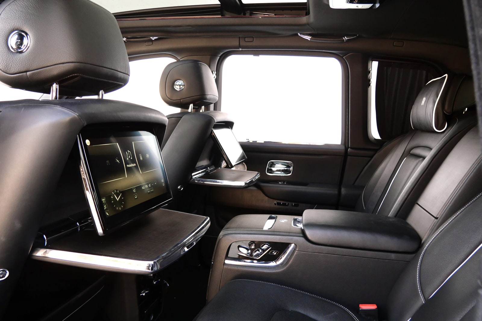 Rear cabin of the Rolls-Royce Cullinan with picnic tables and screens deployed
