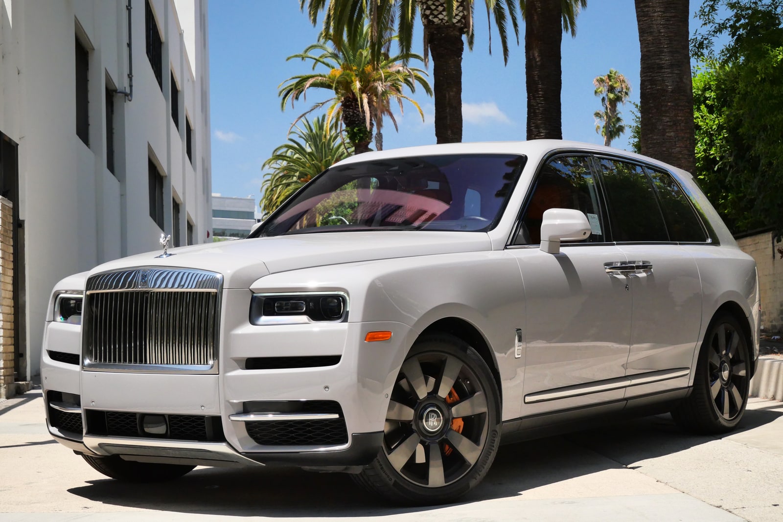White Rolls-Royce Cullinan from a front three-quarter on a Beverly Hills street