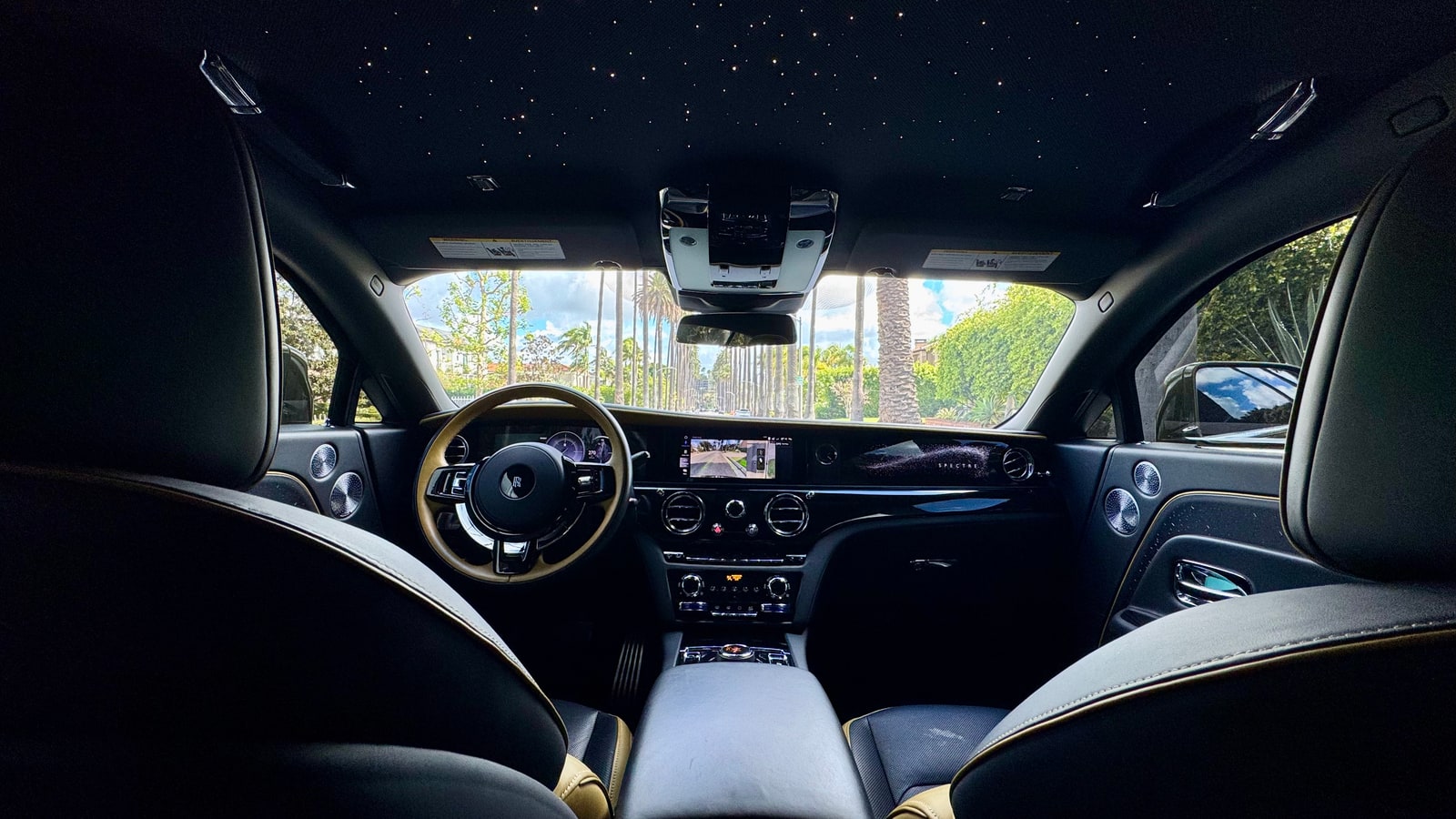 Interior of the Rolls-Royce Spectre from the rear seat with the Starlight headliner