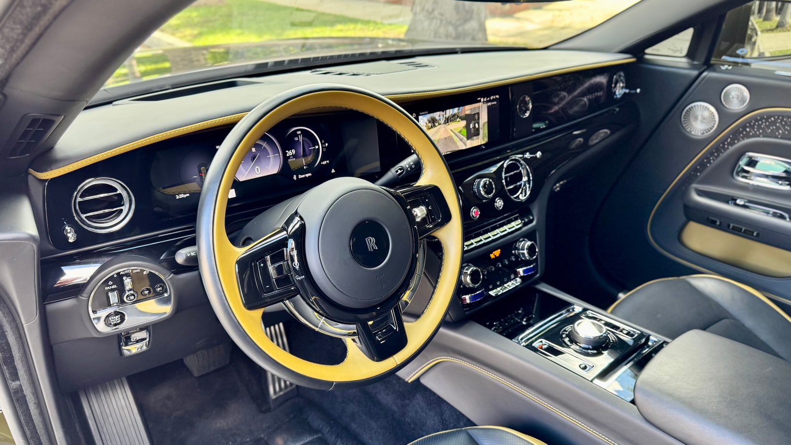 Steering wheel and fascia of the Rolls-Royce Spectre through the driver door