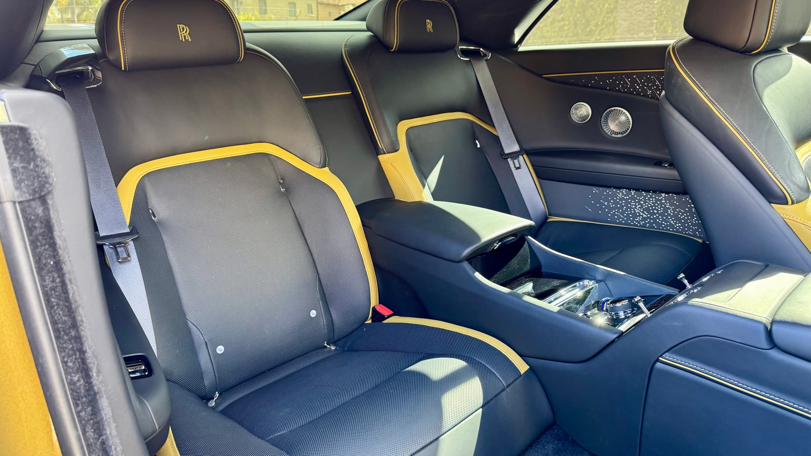 Black leather seat with yellow piping and Starlight door panel in the Rolls-Royce Spectre