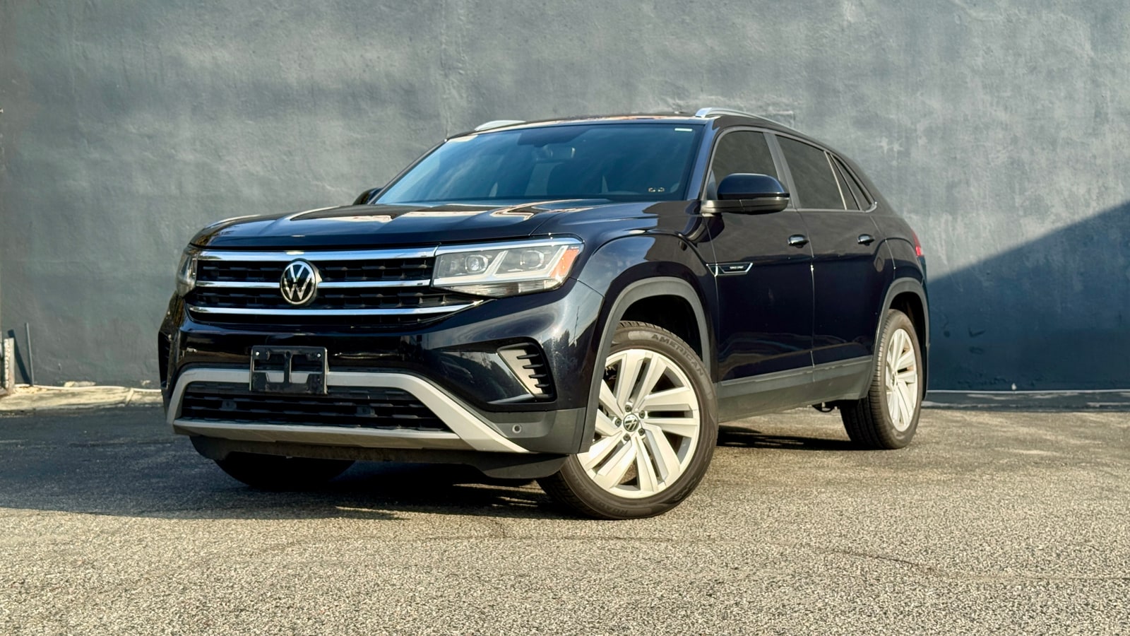 Black Volkswagen Atlas Cross Sport from a front three-quarter