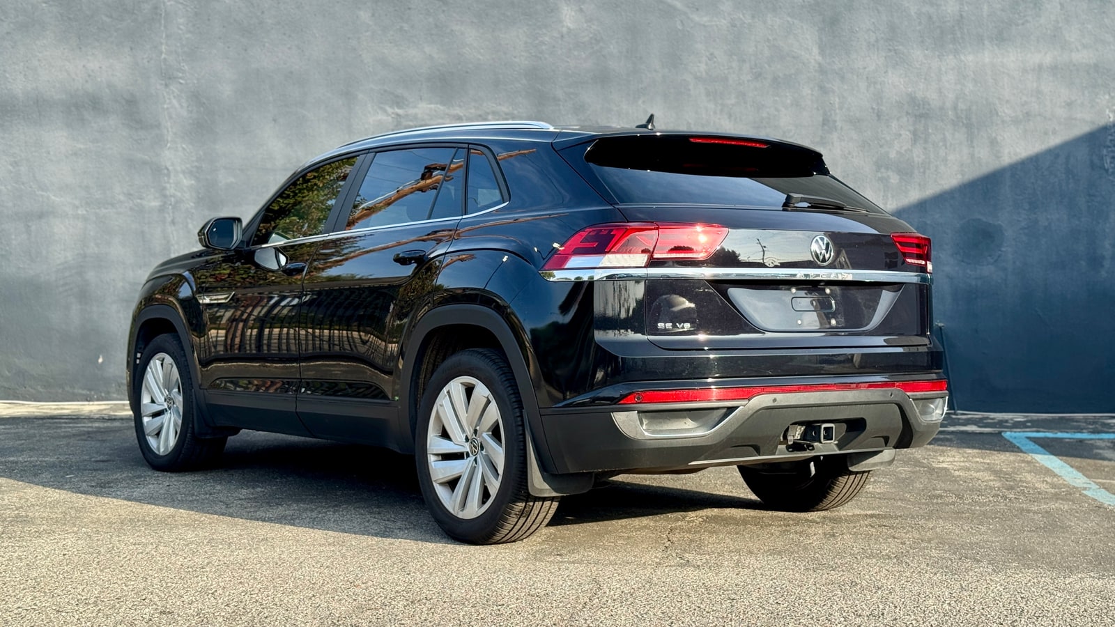 Black Volkswagen Atlas Cross Sport from the rear three-quarter